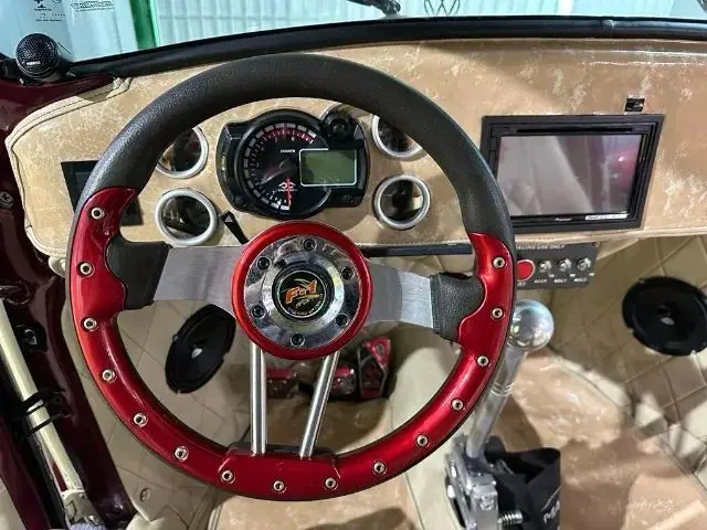 Painel com volante esportivo vermelho, mostradores e tela multimídia